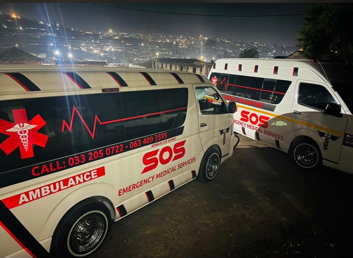 SOS EMS crew beside an ambulance